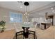 Inviting dining area with elegant lighting is open to the living room and kitchen at 8298 W Agate Ave, Las Vegas, NV 89113