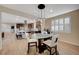 Open dining space leads to modern kitchen with a large island and stainless appliances at 8298 W Agate Ave, Las Vegas, NV 89113