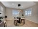 Bright breakfast nook has a modern chandelier and large windows with plantation shutters at 8298 W Agate Ave, Las Vegas, NV 89113