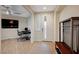 Inviting entryway with adjacent office space, decorative console table, and tiled floors at 8298 W Agate Ave, Las Vegas, NV 89113