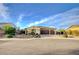Attractive single-story home showcasing desert landscaping, a three-car garage, and a welcoming facade at 8298 W Agate Ave, Las Vegas, NV 89113