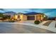 Charming single-story home boasts a three-car garage, desert landscaping, and a warm, inviting facade at 8298 W Agate Ave, Las Vegas, NV 89113