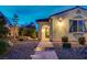 Charming single-story home featuring a tiled entryway, desert landscaping, and a well-lit facade at 8298 W Agate Ave, Las Vegas, NV 89113