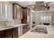 Gourmet kitchen with stainless steel appliances, quartz counters, and custom cabinetry at 8298 W Agate Ave, Las Vegas, NV 89113