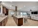 Modern kitchen with island, stainless appliances, opens up into living area and breakfast nook at 8298 W Agate Ave, Las Vegas, NV 89113