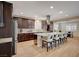 Open kitchen with an island, stainless steel appliances, and an adjacent dining area with a full table set at 8298 W Agate Ave, Las Vegas, NV 89113