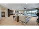 Spacious open-concept living room with wood-style flooring, flowing into the kitchen and dining areas at 8298 W Agate Ave, Las Vegas, NV 89113