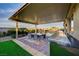 Covered patio features an outdoor kitchen and dining area with a view of the pool at 8298 W Agate Ave, Las Vegas, NV 89113