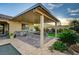 Covered outdoor kitchen with stainless steel grill and beautiful backyard seating area at 8298 W Agate Ave, Las Vegas, NV 89113