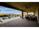 Expansive covered patio with comfortable seating and views of the sparkling pool and lush landscaping at 8298 W Agate Ave, Las Vegas, NV 89113