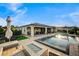 Resort style pool with a fire pit and patio seating in a backyard oasis at 8298 W Agate Ave, Las Vegas, NV 89113