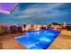 Beautiful backyard with a sparkling pool, a fire feature, and desert landscaping at 8298 W Agate Ave, Las Vegas, NV 89113