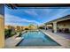 Backyard swimming pool with a tanning ledge and an outdoor seating area at 8298 W Agate Ave, Las Vegas, NV 89113