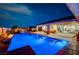 Inviting outdoor pool area with stylish patio, outdoor kitchen, and cozy seating, perfect for entertaining guests at 8298 W Agate Ave, Las Vegas, NV 89113