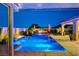 Gorgeous pool at dusk featuring a fire pit, deck chairs and umbrellas, perfect for relaxation and outdoor enjoyment at 8298 W Agate Ave, Las Vegas, NV 89113