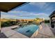 Beautiful backyard pool featuring multiple seating areas and lush landscaping at 8298 W Agate Ave, Las Vegas, NV 89113