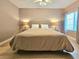Comfortable bedroom with plush bedding, stylish lamps, neutral tones and a large window at 9000 S Las Vegas Blvd # 1187, Las Vegas, NV 89123