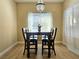 Bright dining area with a modern chandelier, wood-style flooring, and a view of the outdoors at 9000 S Las Vegas Blvd # 1187, Las Vegas, NV 89123
