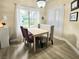Bright dining area featuring a table, chairs, bench, and a large window with natural light at 9000 S Las Vegas Blvd # 1187, Las Vegas, NV 89123