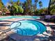 Community hot tub and resort-style pool with lounge seating, palm trees and well-maintained grounds at 9000 S Las Vegas Blvd # 1187, Las Vegas, NV 89123
