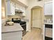 Well-lit kitchen with a gas range, white cabinets, and wood-look flooring at 9000 S Las Vegas Blvd # 1187, Las Vegas, NV 89123