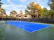 Bright blue tennis court surrounded by lush greenery offering a great amenity for residents at 9000 S Las Vegas Blvd # 1187, Las Vegas, NV 89123