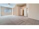 Bare bedroom with plush carpet and a large window offering a clean canvas for a personalized touch at 914 Calico Brook Dr, Henderson, NV 89002