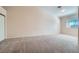 Bare bedroom with plush carpet and a large window offering a clean canvas for a personalized touch at 914 Calico Brook Dr, Henderson, NV 89002