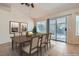 Dining area with tile floors, light-colored walls, a sliding glass door, and dining table at 914 Calico Brook Dr, Henderson, NV 89002