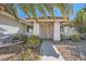 View of a home's entrance, with a metal security door and desert landscaping at 914 Calico Brook Dr, Henderson, NV 89002