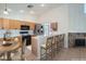 Open kitchen with light-colored cabinets, tile floors, a breakfast bar, and modern appliances at 914 Calico Brook Dr, Henderson, NV 89002