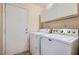 Laundry room with washer, dryer and overhead storage at 914 Calico Brook Dr, Henderson, NV 89002