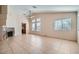 Open living room with a fireplace, light colored walls, tile floor, and abundant natural light at 914 Calico Brook Dr, Henderson, NV 89002
