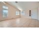 Open living room with light-colored walls, tile floors, and a sliding glass door with outside access at 914 Calico Brook Dr, Henderson, NV 89002