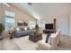 Vaulted living room featuring a ceiling fan, neutral walls, a fireplace, and multiple windows at 914 Calico Brook Dr, Henderson, NV 89002