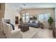 Bright living room featuring a ceiling fan, neutral walls, a fireplace, and multiple windows at 914 Calico Brook Dr, Henderson, NV 89002