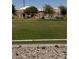 Community park featuring a playground, benches, and expansive green space on a sunny day at 914 Calico Brook Dr, Henderson, NV 89002