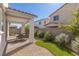 A spacious patio area and curated desert landscaping offer low-maintenance beauty in this backyard at 9233 Far Side Ave, Las Vegas, NV 89143