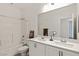 Bright bathroom featuring a double vanity, a toilet, and shower-tub combo at 9233 Far Side Ave, Las Vegas, NV 89143