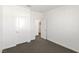 A simple, bright bedroom with a neutral color scheme, carpet flooring, and standard doors at 9233 Far Side Ave, Las Vegas, NV 89143