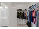 Walk-in closet with shelving and clothing racks, and views into the Primary bathroom at 9233 Far Side Ave, Las Vegas, NV 89143