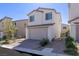 Charming two-story home with brick driveway, a two-car garage, and desert-friendly landscaping at 9233 Far Side Ave, Las Vegas, NV 89143
