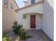 Inviting home featuring a beautiful, paneled front door and desert-friendly landscaping at 9233 Far Side Ave, Las Vegas, NV 89143