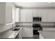 Bright kitchen with stainless steel appliances, including microwave and gas range, and plenty of white cabinets at 9233 Far Side Ave, Las Vegas, NV 89143