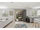 Bright living space with modern white furniture, large windows and sliding door to the rear patio at 9233 Far Side Ave, Las Vegas, NV 89143