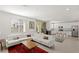 Open-concept living space with a comfortable white sofa, modern kitchen, and plenty of natural light at 9233 Far Side Ave, Las Vegas, NV 89143