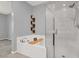 A modern bathroom featuring a soaking tub and a shower with glass door at 965 Nevada State Dr # 36102, Henderson, NV 89002