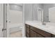 Modern bathroom with a white subway tile surround bathtub and stylish vanity with updated plumbing fixtures at 965 Nevada State Dr # 36102, Henderson, NV 89002