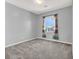 A carpeted bedroom featuring a window with stylish curtains at 965 Nevada State Dr # 36102, Henderson, NV 89002