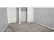 Bright bedroom with neutral carpet, base trim, and paint, two doors, and a closet with a hanging rod at 965 Nevada State Dr # 36102, Henderson, NV 89002